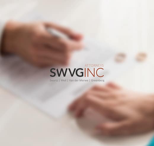 SWVG Inc Attorneys – Family Law Close-up of hands over divorce paperwork with wedding rings on the table, illustrating family law services including divorce, parenting arrangements and protection orders.