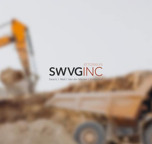 SWVG Inc Attorneys – Mining Law Excavator loading a dump truck at a mining site - representing mining rights, compliance and dispute support.